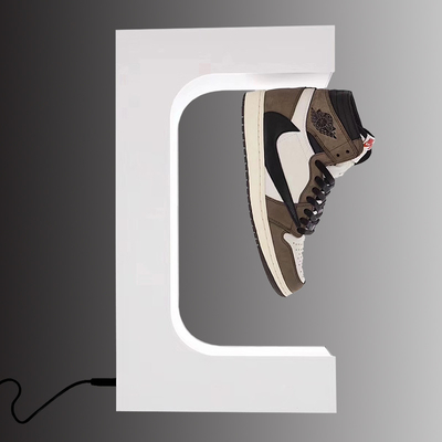 Il modo che levitano il banco di mostra di galleggiamento magnetico delle scarpe e l'esposizione del negozio per l'immaginazione delle scarpe dividono il visualizzatore delle scarpe bianco
