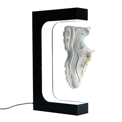 Il modo che levitano il banco di mostra di galleggiamento magnetico delle scarpe e l'esposizione del negozio per l'immaginazione delle scarpe dividono il visualizzatore delle scarpe bianco